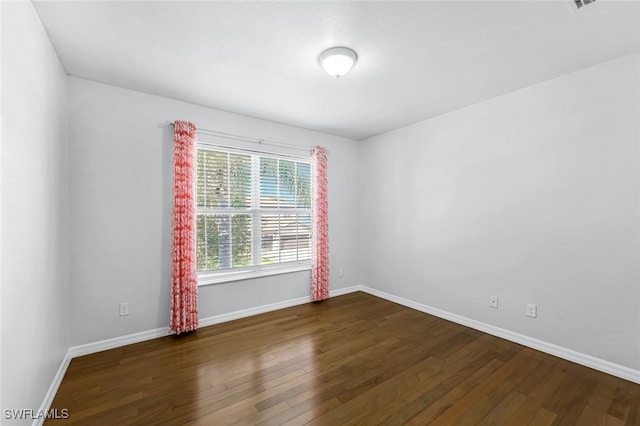 empty room featuring dark hardwood / wood-style flooring