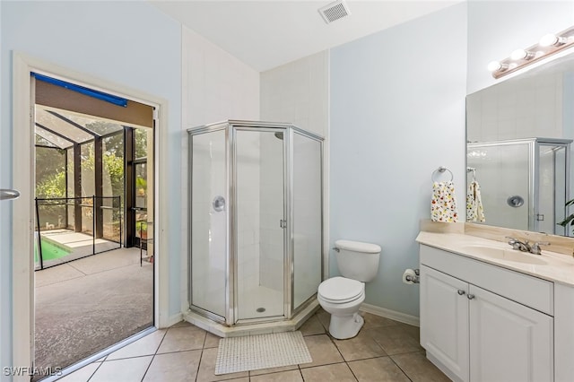 bathroom with tile patterned flooring, vanity, toilet, and walk in shower