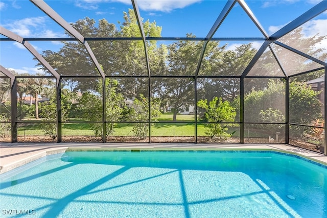 view of swimming pool featuring a lanai