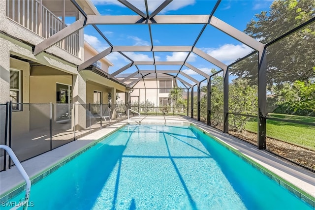 view of swimming pool featuring a lanai and a patio