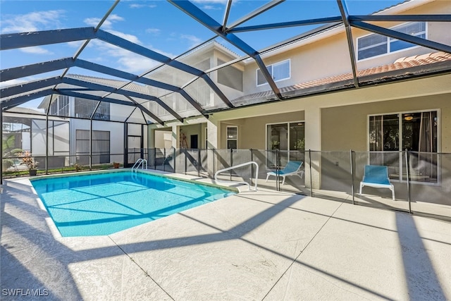 view of swimming pool featuring a patio and a lanai