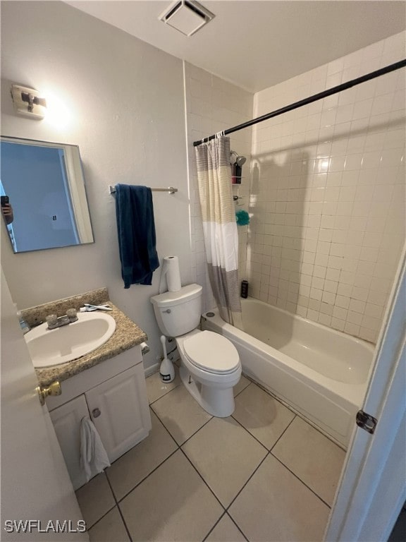 full bathroom featuring tile patterned floors, vanity, shower / bath combination with curtain, and toilet