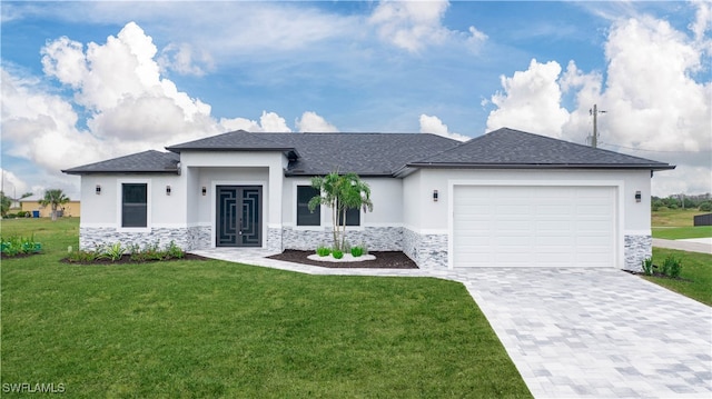 view of front of house with a front yard, french doors, and a garage