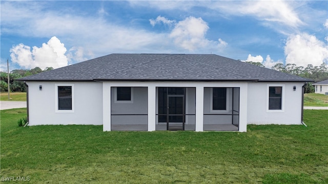 back of house with a sunroom and a yard