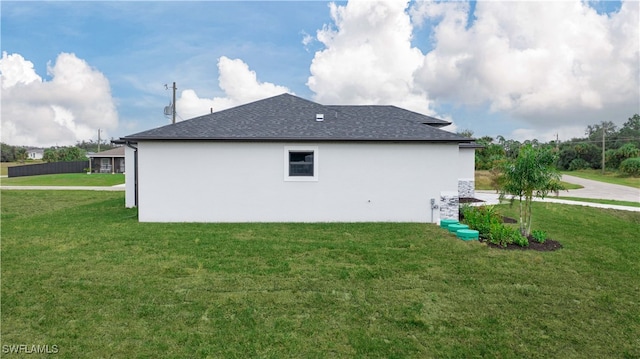 view of side of property with a yard