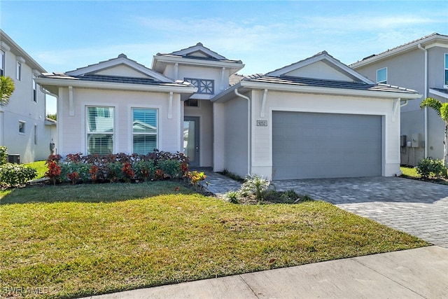 view of front of property with a garage and a front lawn