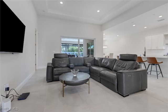 living room with a tray ceiling