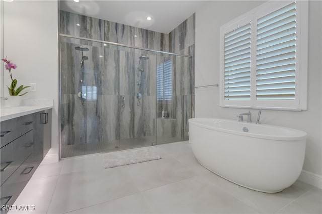 bathroom with tile patterned flooring, vanity, and independent shower and bath