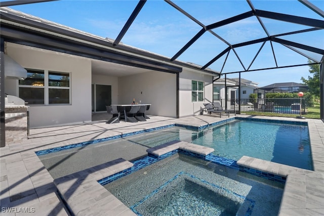 view of swimming pool featuring an in ground hot tub, a lanai, and a patio area