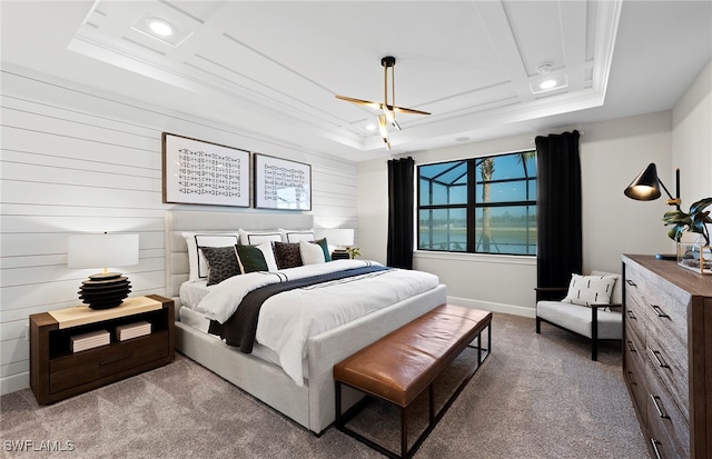 bedroom with a tray ceiling, ceiling fan, light colored carpet, and ornamental molding