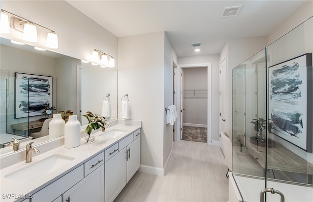 bathroom with tile patterned floors, vanity, and walk in shower