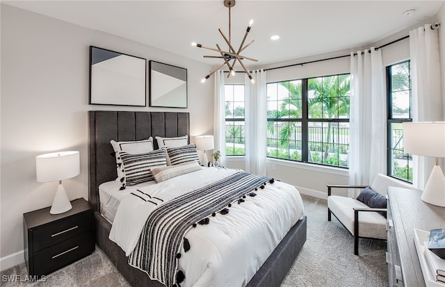 bedroom with a notable chandelier, light carpet, and multiple windows