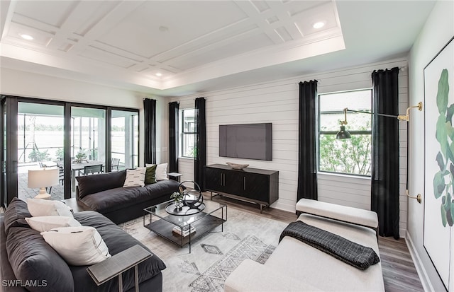 living room with coffered ceiling and light wood-type flooring