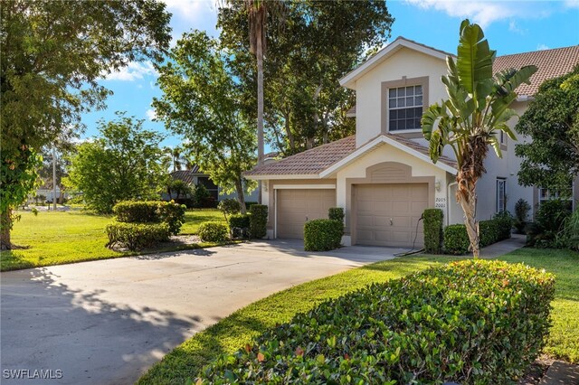 255 Cays Dr Unit 2001, Naples, FL 34114 - view of front facade with stucco siding, concrete driveway, a tiled roof, and a front yard