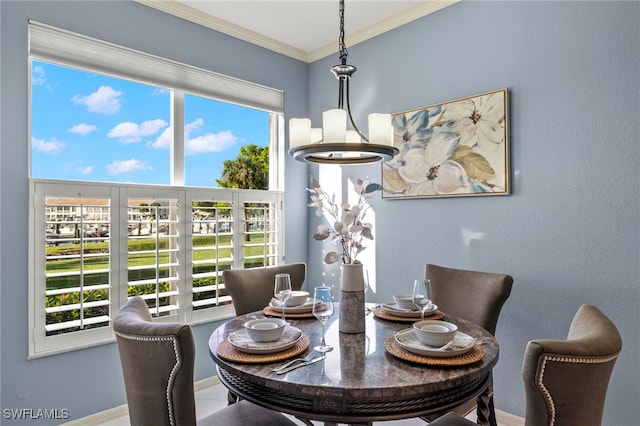 dining space featuring ornamental molding and a chandelier