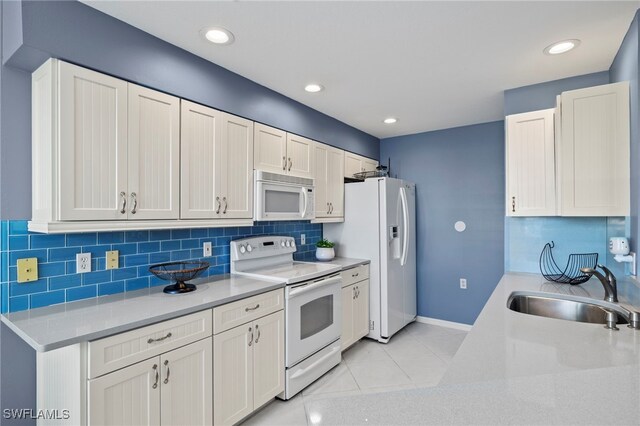 255 Cays Dr Unit 2001, Naples, FL 34114 - kitchen with white appliances, a sink, tasteful backsplash, light countertops, and recessed lighting