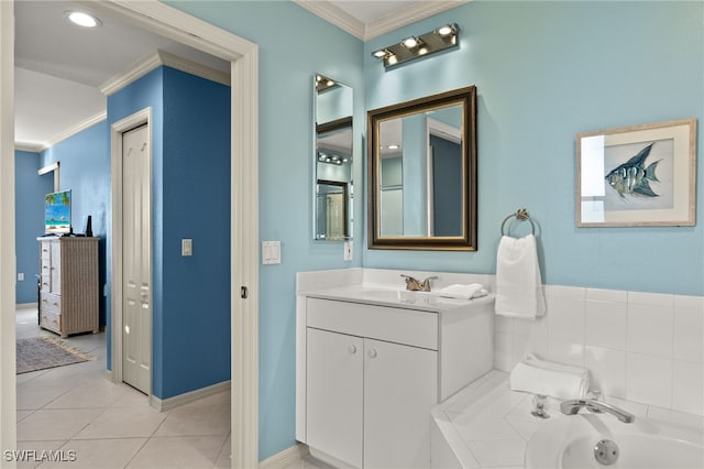 bathroom with tiled tub, crown molding, tile patterned flooring, and vanity