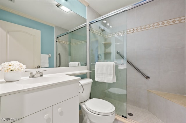 bathroom featuring vanity, toilet, and an enclosed shower