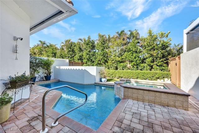 view of swimming pool with an in ground hot tub and a patio