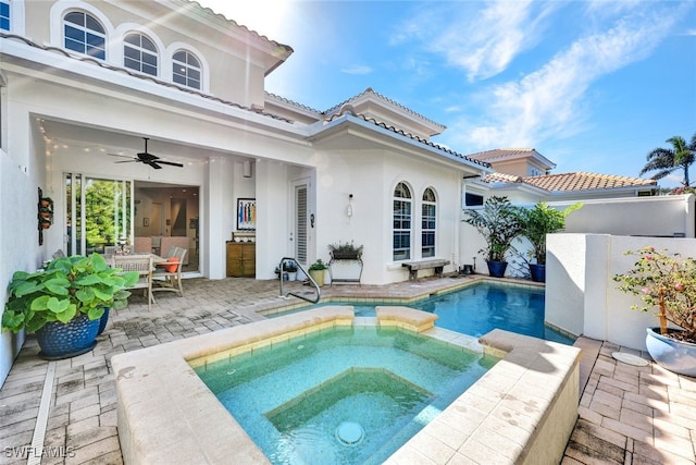 view of pool with an in ground hot tub, ceiling fan, and a patio area