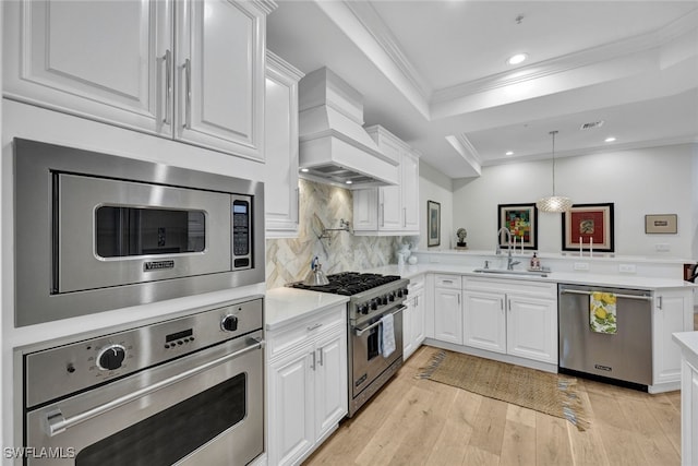 kitchen with custom exhaust hood, sink, white cabinetry, and stainless steel appliances