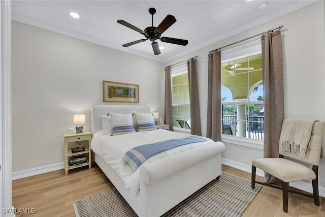 bedroom with multiple windows, ceiling fan, crown molding, and light hardwood / wood-style floors