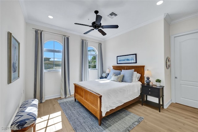 bedroom with light wood-type flooring, ceiling fan, and crown molding