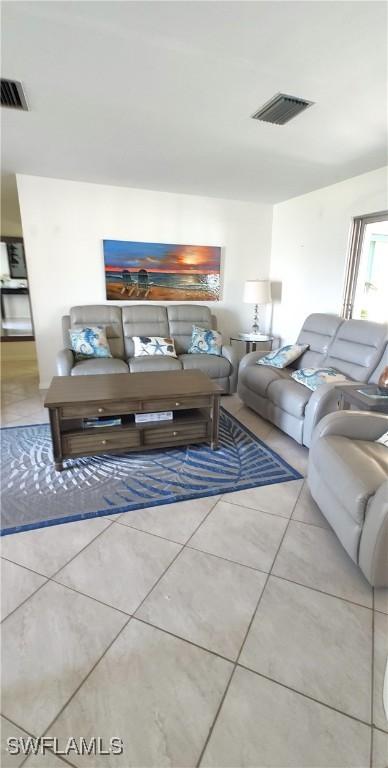 living area featuring tile patterned flooring and visible vents