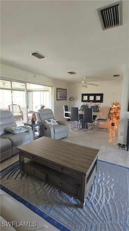 tiled living room with ceiling fan