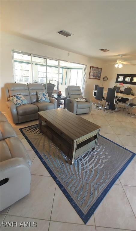 tiled living area featuring visible vents and a ceiling fan