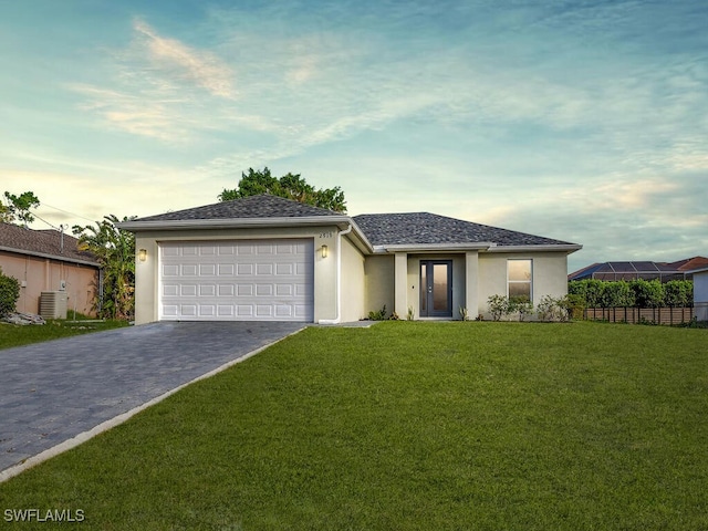 ranch-style house featuring central AC unit, a front yard, and a garage