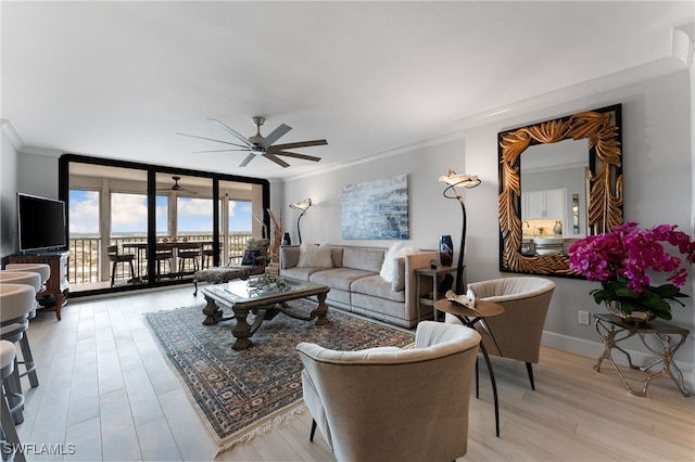 living room featuring light hardwood / wood-style flooring, a wall of windows, ornamental molding, and ceiling fan