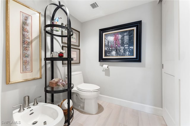 bathroom with toilet, sink, and a bidet