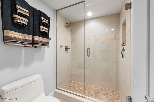 bathroom featuring toilet and walk in shower