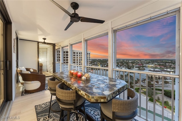 sunroom featuring ceiling fan