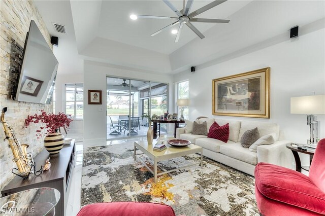 living area with visible vents and a ceiling fan