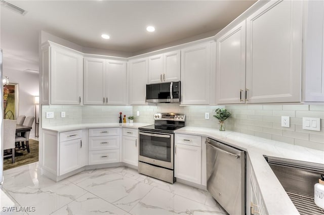 kitchen with visible vents, marble finish floor, white cabinetry, recessed lighting, and appliances with stainless steel finishes