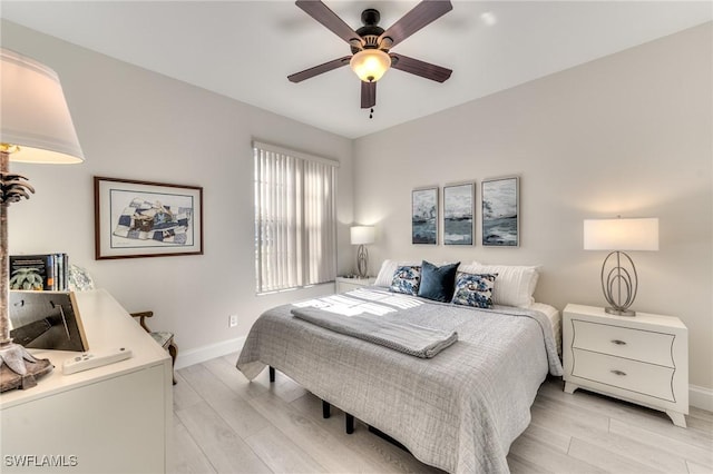 bedroom with baseboards, light wood-style floors, and ceiling fan