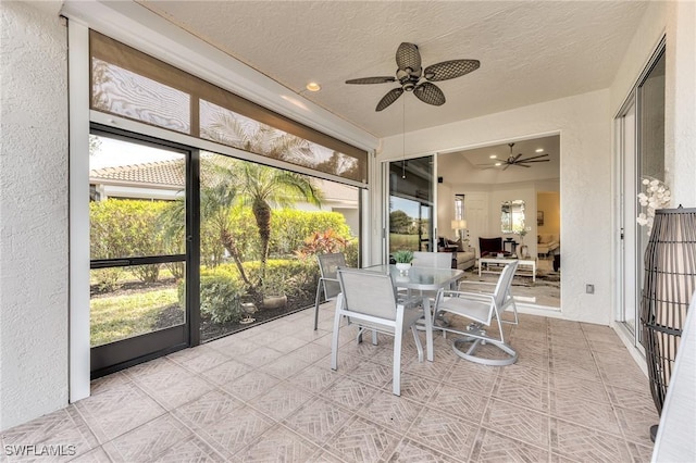 sunroom with a ceiling fan