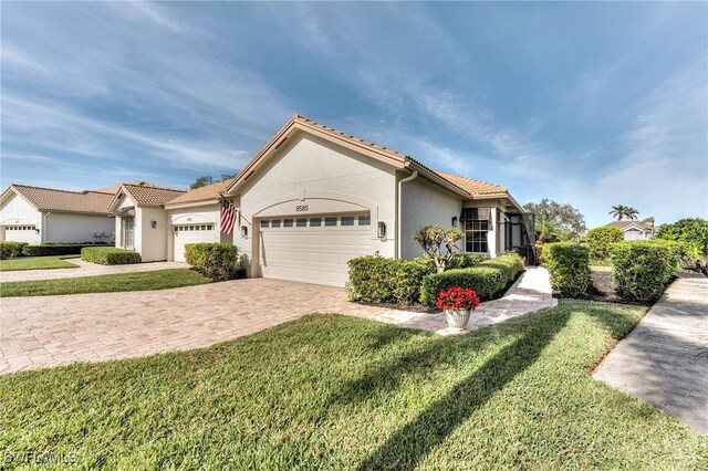 view of front of property featuring a garage and a front yard