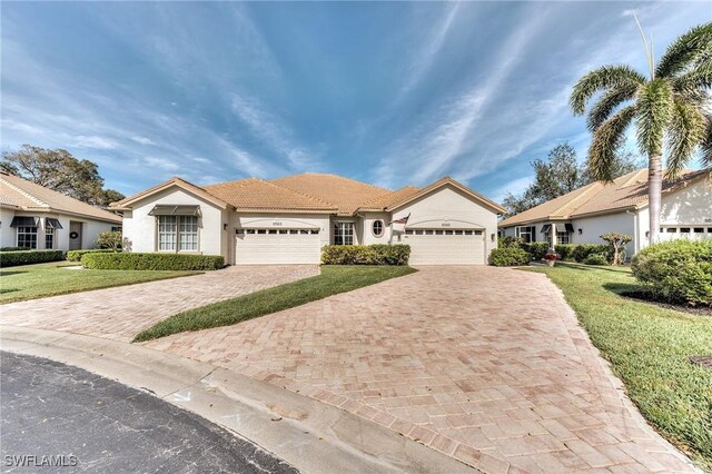 single story home featuring a front yard and a garage