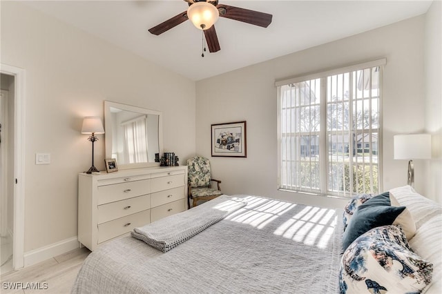 bedroom featuring baseboards and a ceiling fan