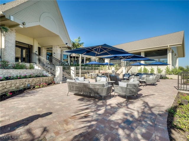 view of patio with an outdoor living space and stairs