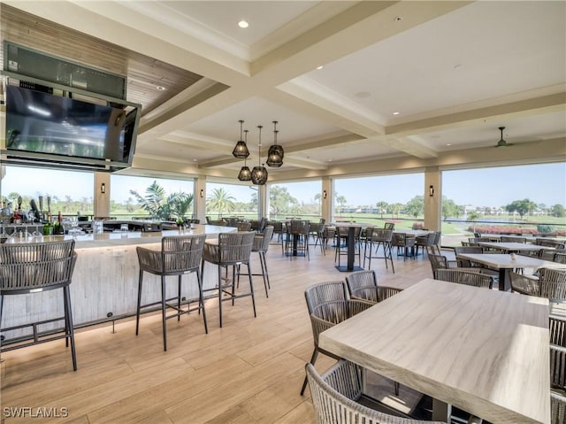 exterior space with light wood finished floors, a healthy amount of sunlight, and coffered ceiling