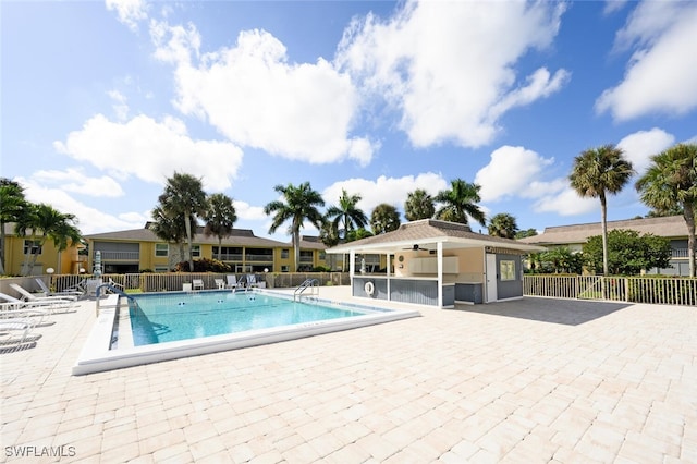 view of pool featuring ceiling fan and a patio