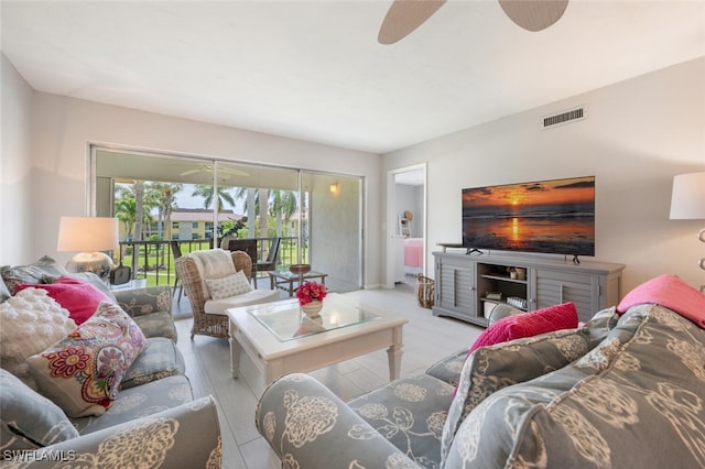 living room with ceiling fan and light wood-type flooring