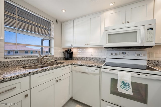 kitchen featuring white cabinets, decorative backsplash, white appliances, and sink