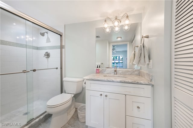 bathroom featuring tile patterned floors, vanity, toilet, and walk in shower