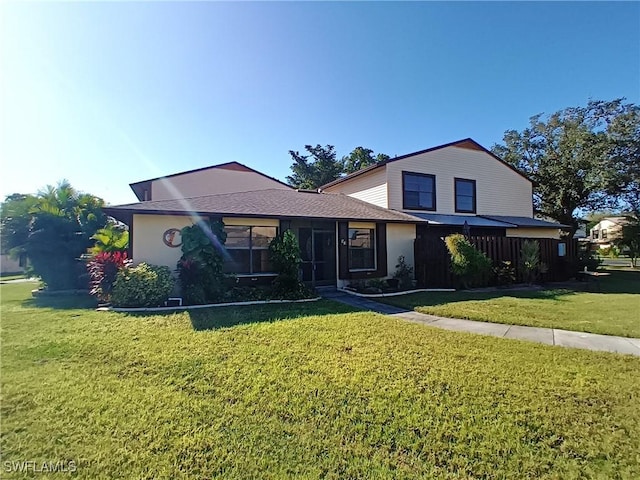 front of property featuring a sunroom and a front yard