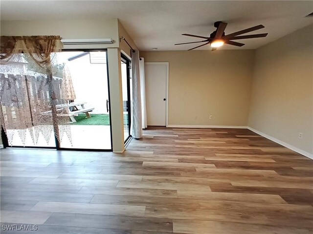 spare room with ceiling fan and light wood-type flooring